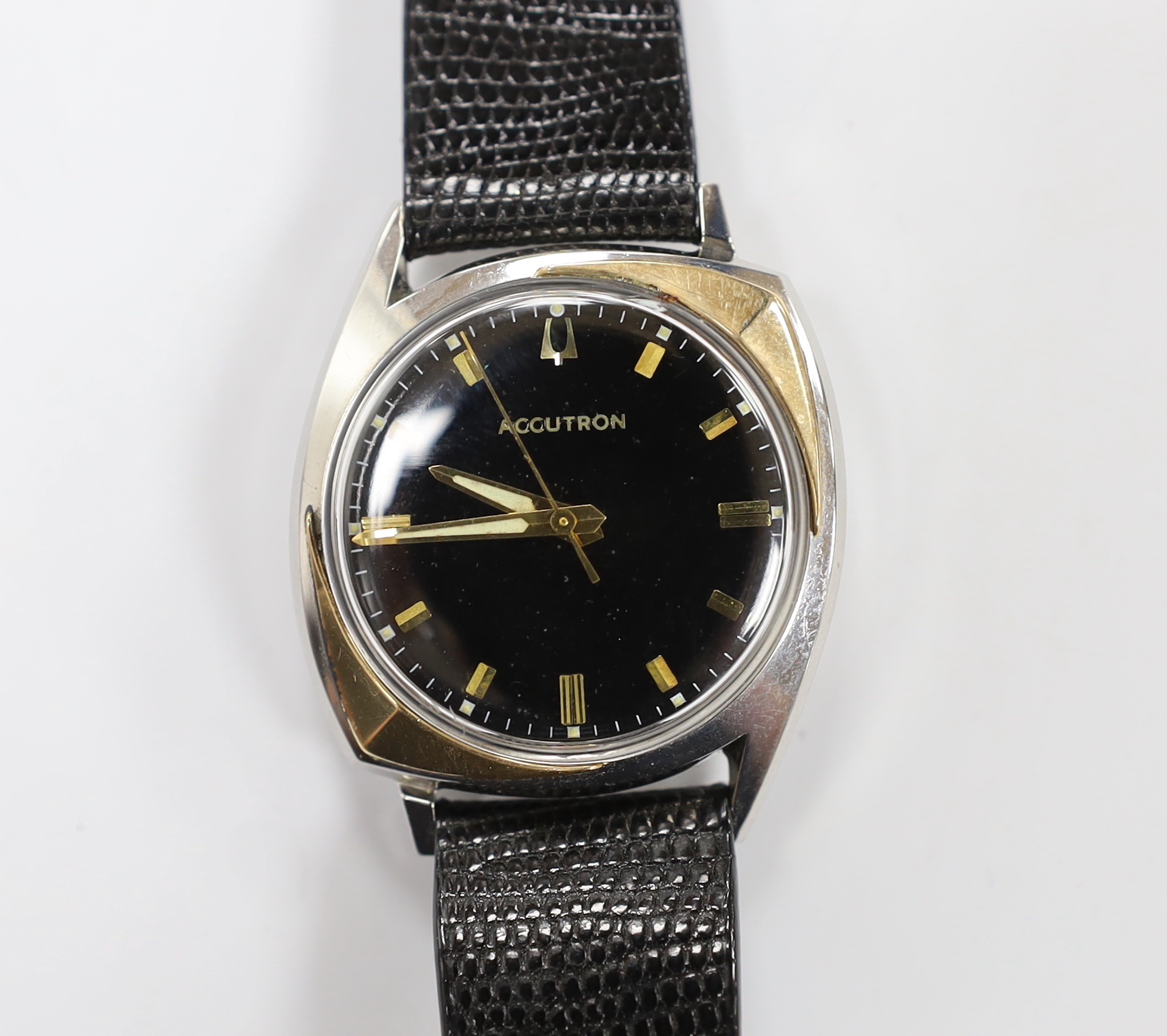 A gentleman's stainless steel Bulova Accutron wrist watch, with black dial, on an Accutron strap, case diameter 33mm.